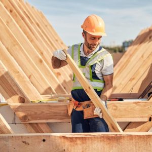 focused-builder-is-adjusting-a-wooden-bar-to-a-roof-carcass-1024x682-1.jpg